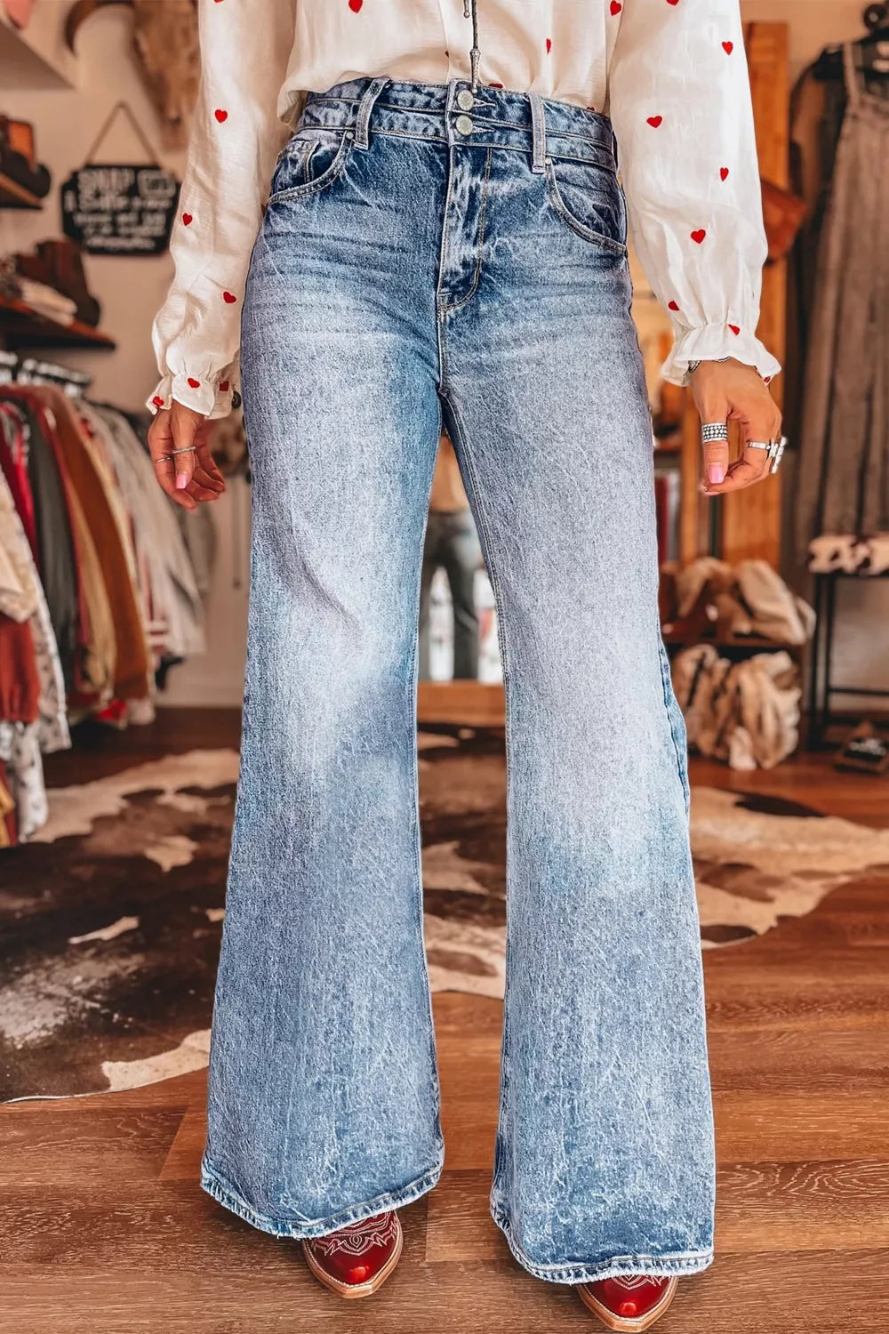 Acid wash flare jeans with pocket details from Plush Fashion Hub, showcasing a stylish, vintage-inspired denim look.