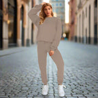 Women's solid color round neck sweatshirt and pants set by Plush Fashion Hub, casualwear with a relaxed fit and comfortable fabric.