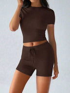 Trendsi active wear set with a round neck short sleeve top and matching shorts, made from breathable fabric, perfect for workouts.