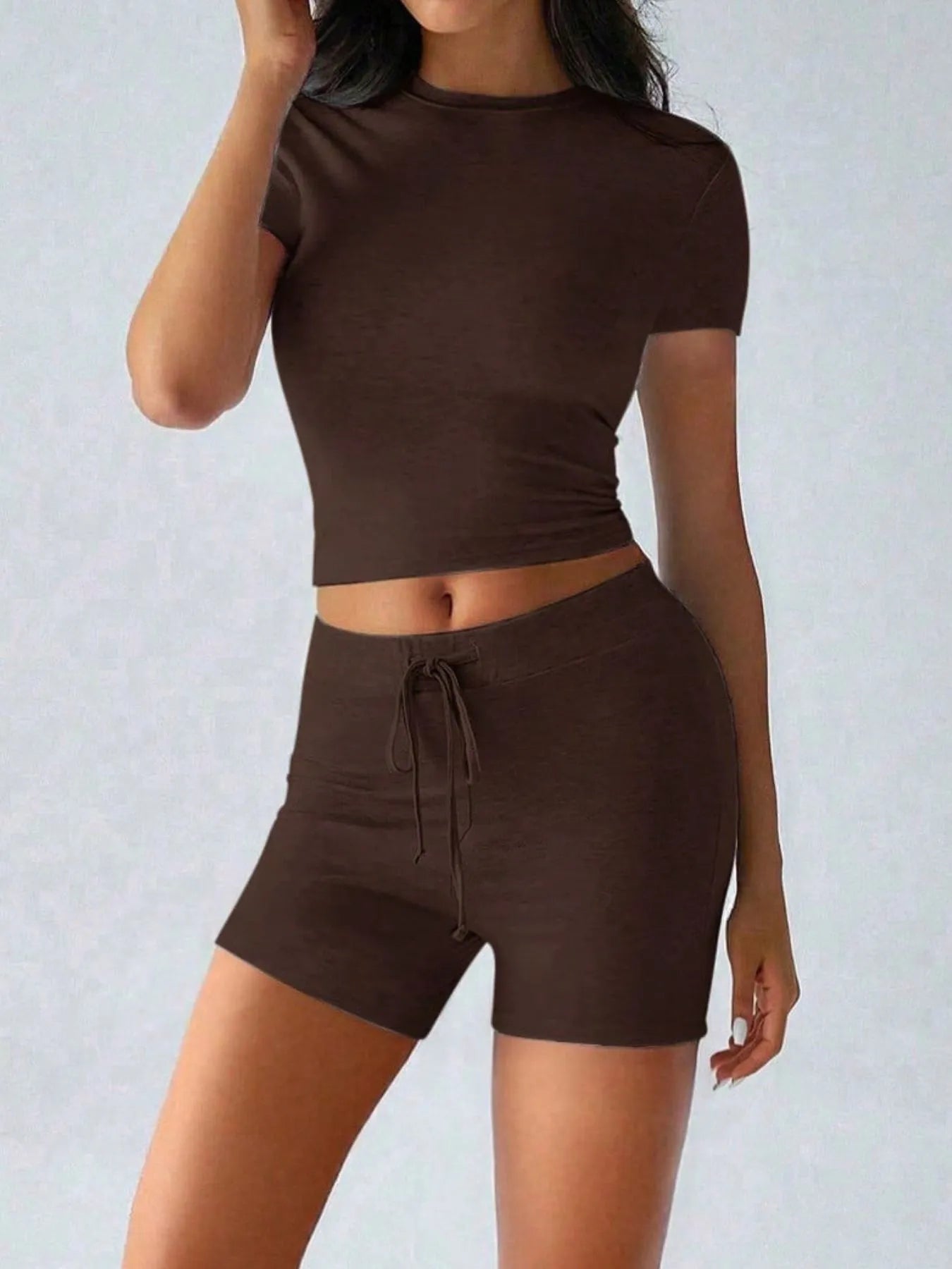 Trendsi active wear set with a round neck short sleeve top and matching shorts, made from breathable fabric, perfect for workouts.