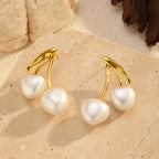Pearl cherry drop earrings by Shopimist featuring pearl and red cherry-shaped charms on delicate gold hooks.