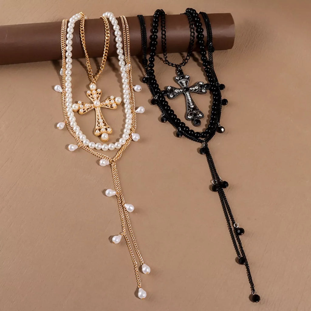 Pearl cross pendant necklace set with three elegant necklaces featuring pearl and cross designs, by Shopimist.