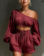 Women's one-shoulder ruched crop top and high-waist shorts set by Plush Fashion Hub, featuring stylish, coordinated fashion ensemble.