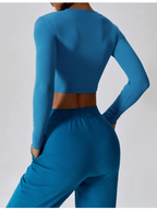 Women’s slim fit long sleeve yoga top by Plush Fashion Hub, made of breathable activewear fabric, shown in a close-up image.