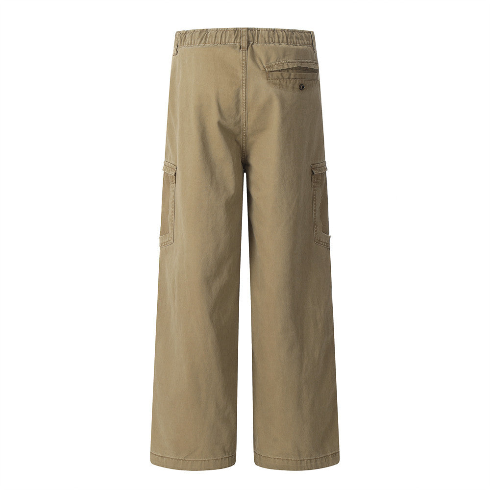 Back view of khaki cotton cargo pants with side pockets, elastic waistband, and wide straight legs.