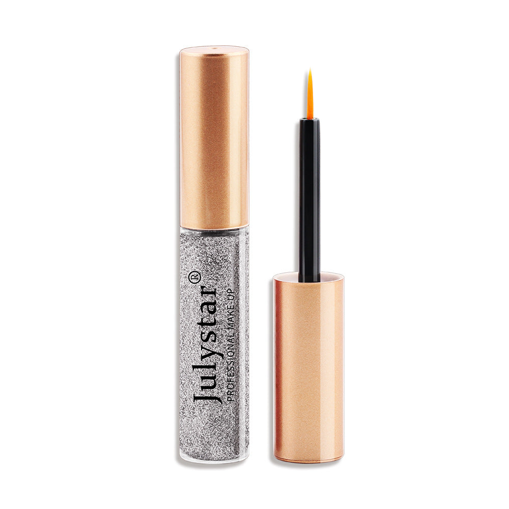 Julystar liquid eyeliner with a silver glitter tube, rose gold cap, and fine brush applicator.