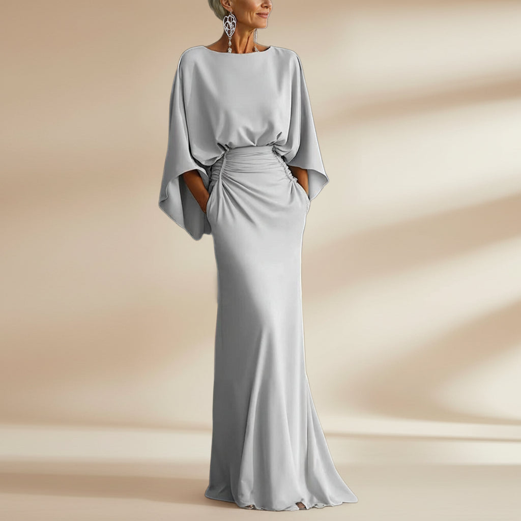 Women's silver backless pleated batwing sleeve maxi dress by FitiqueFit, featuring a mermaid silhouette and elegant design.