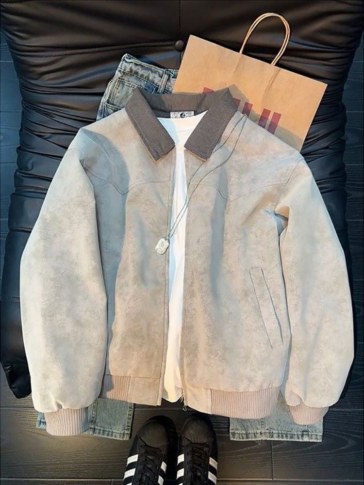 Grey suede bomber jacket with contrasting ribbed collar, cuffs, and hem, layered over a white t-shirt.