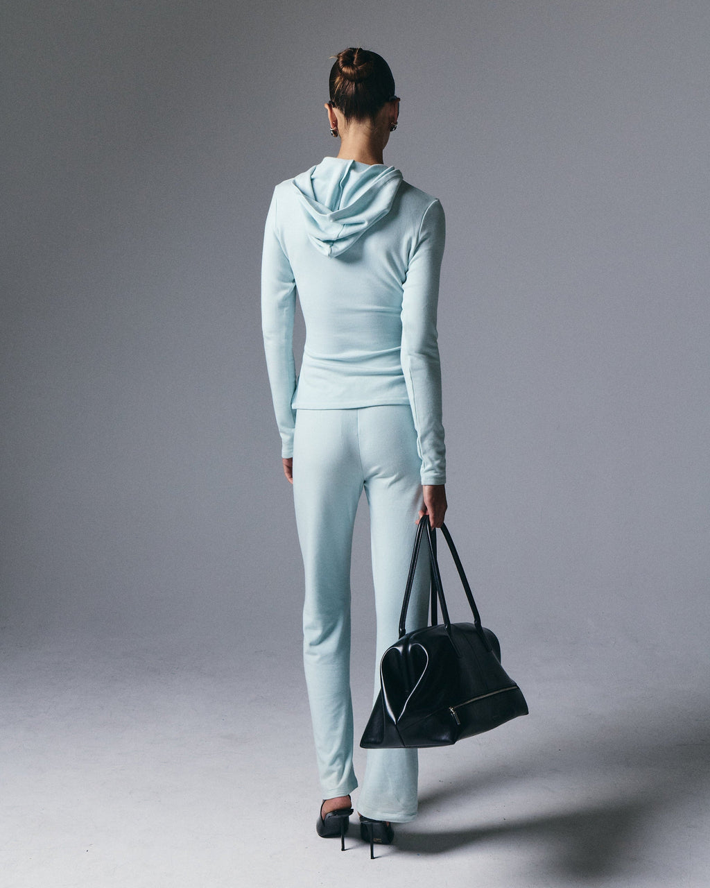 Artless Forever Leni Hooded Top displayed on a model, featuring a stylish hooded design and casual fit.