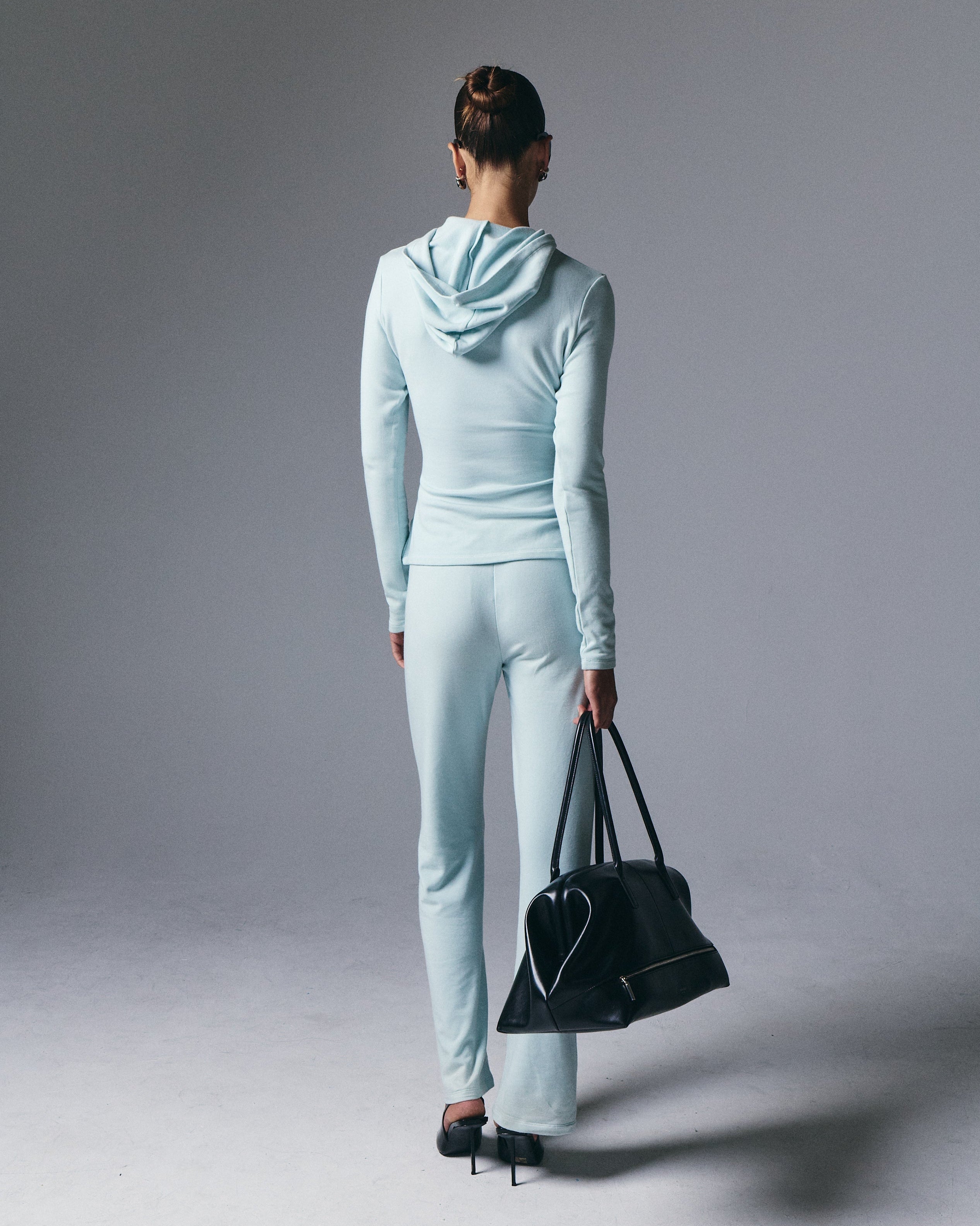 Artless Forever Leni Hooded Top displayed on a model, featuring a stylish hooded design and casual fit.