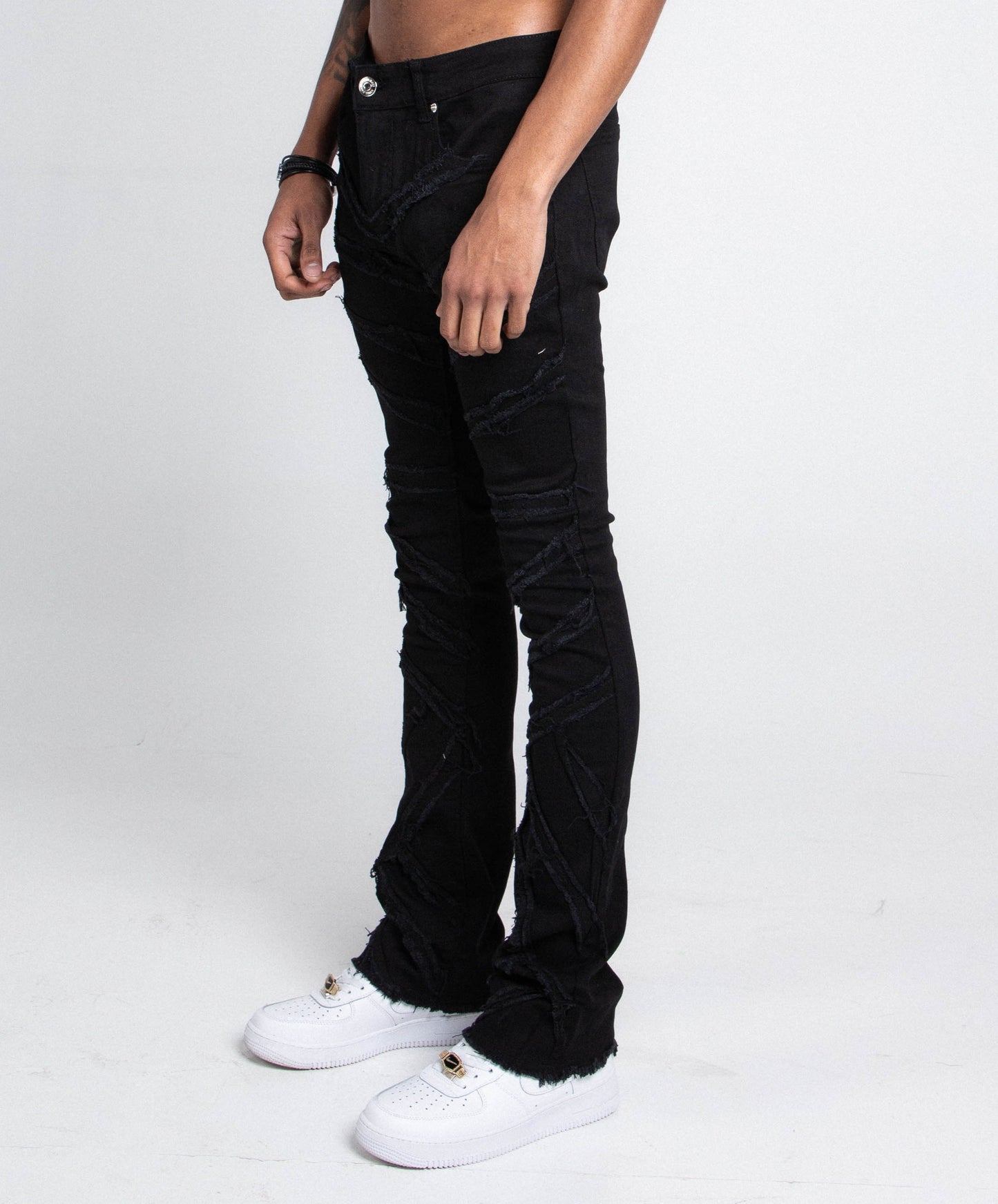 Shredded stacked jeans by Plush Fashion Hub, showing distressed denim pants with layered, torn details and a modern fit.