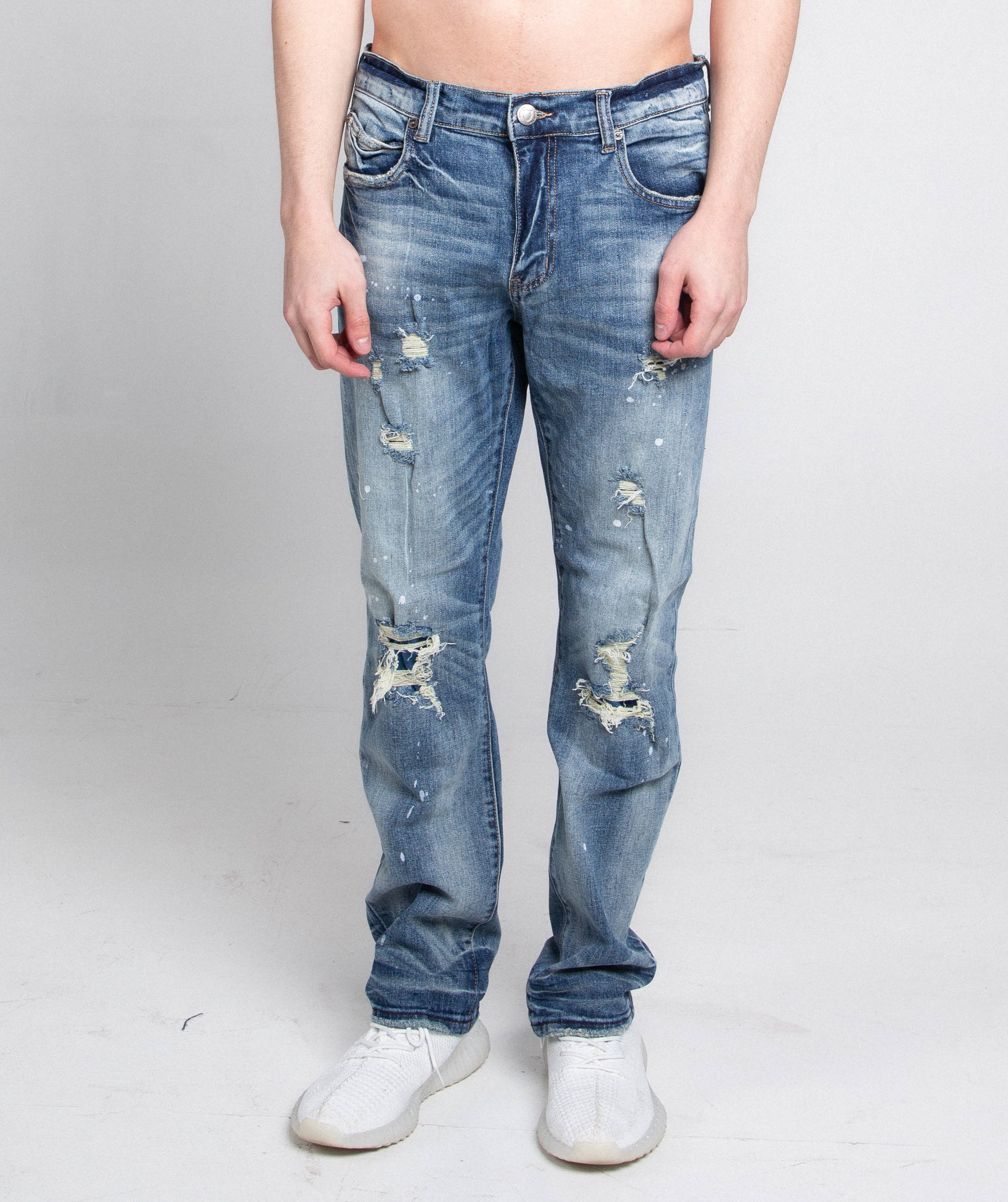 Distressed casual skinny jeans by Armor Jeans featuring ripped details and a fitted style, shown in a front view.