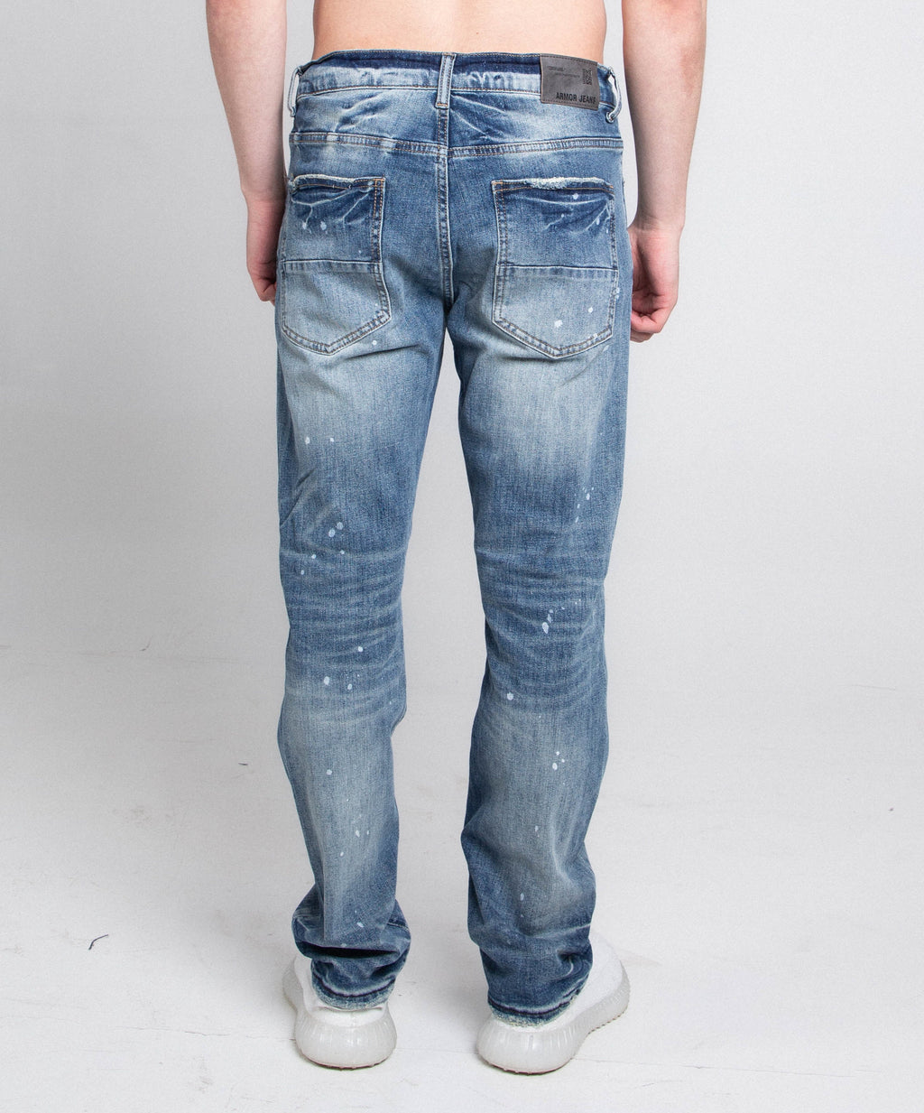 Distressed casual skinny jeans by Armor Jeans, showing a close-up of the worn, ripped denim fabric and slim-fit style.