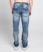 Distressed casual skinny jeans by Armor Jeans, showing a close-up of the worn, ripped denim fabric and slim-fit style.
