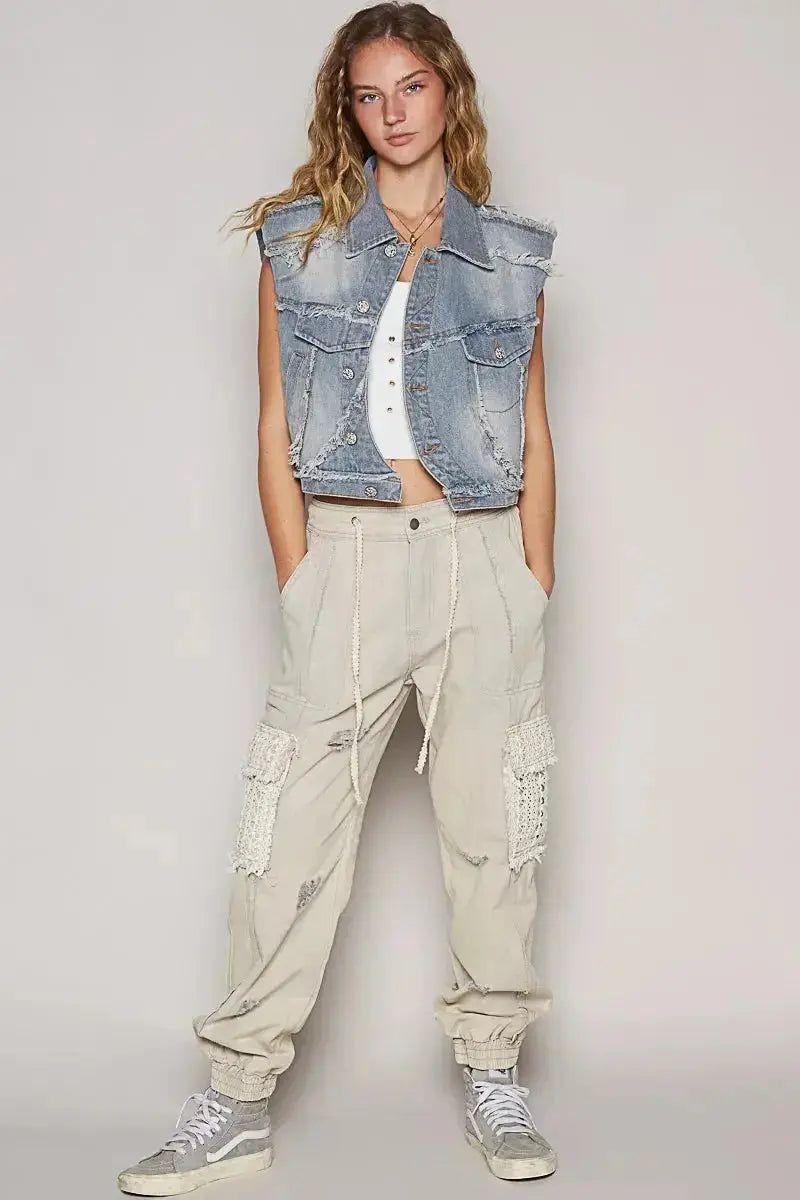 Asymmetrical distressed denim vest with raw hem, sleeveless jean jacket from Trendsi, styled with casual urban fashion.