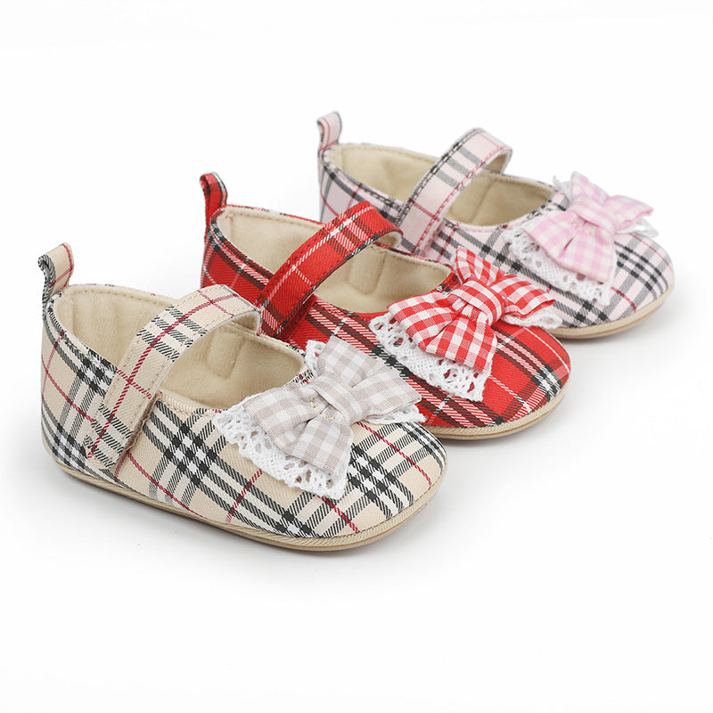 Three pairs of baby plaid shoes in beige, red, and pink, featuring lace-trimmed bows and strap closures.