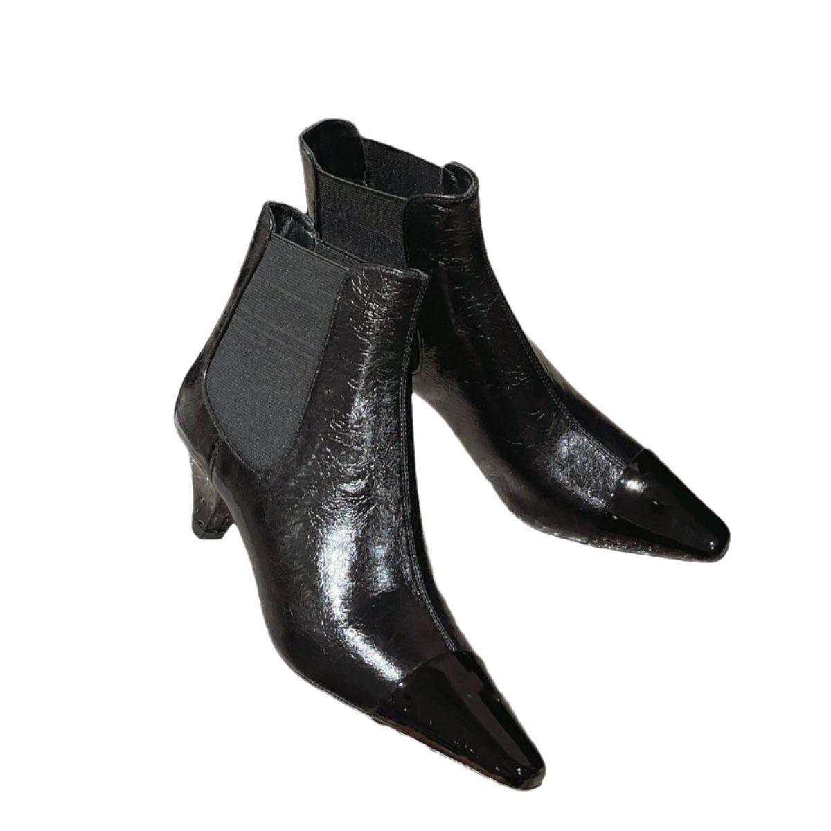 Black patent leather Chelsea boots with pointed toes, side gore panels, and kitten heels.