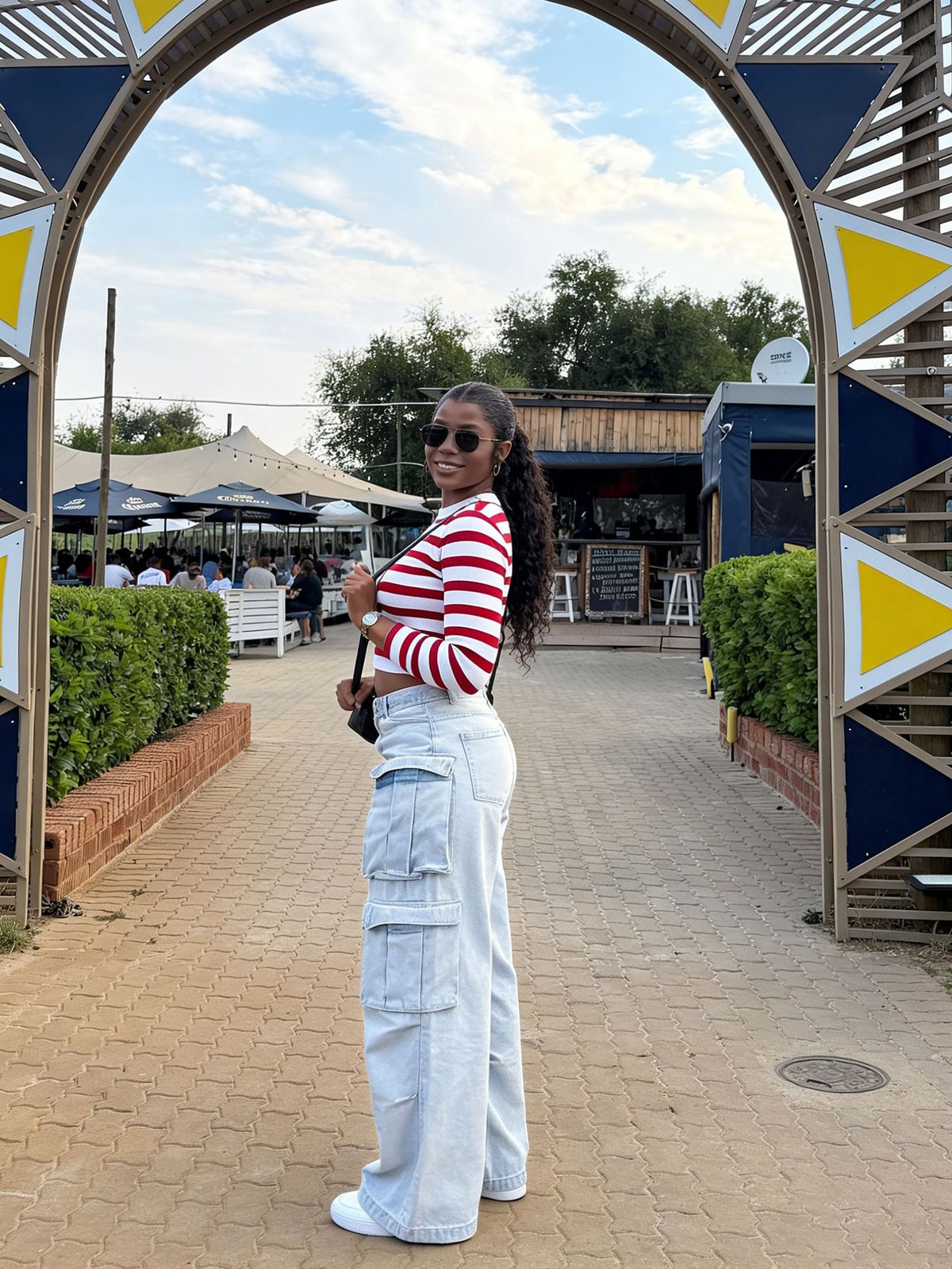 Light wash cargo jeans pants with multiple pockets and street style design by eprolo, shown on a model.