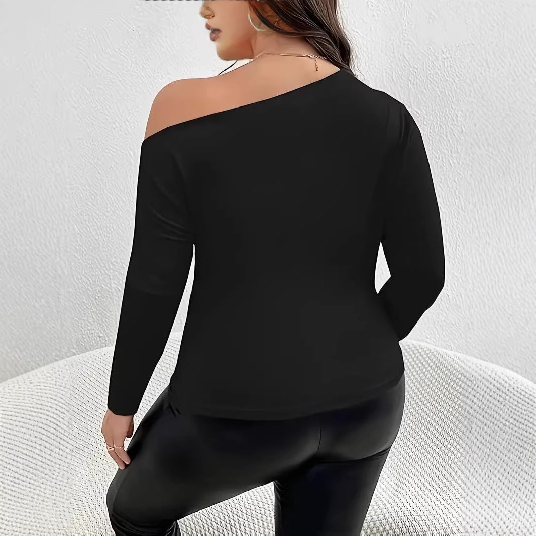Back view of a plain black one-shoulder long-sleeve top in soft knit fabric, paired with black shiny pants.