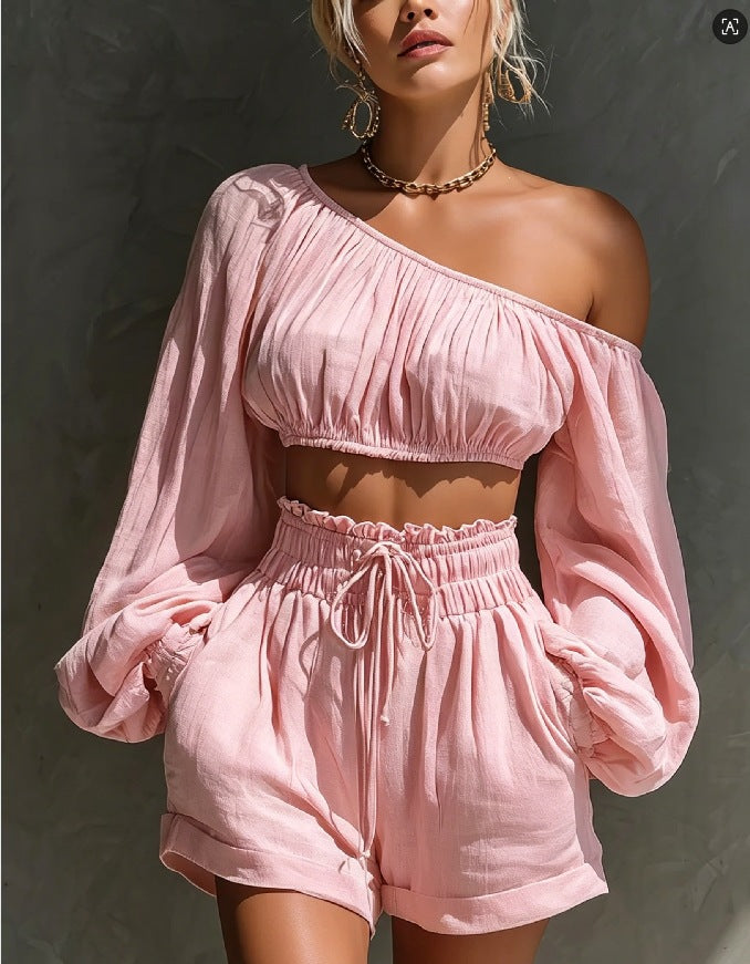 Women's one-shoulder ruched crop top and high-waist shorts set by Plush Fashion Hub, styled together for a trendy summer look.