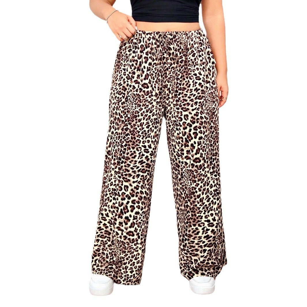 Leopard print wide-leg pants with a high elastic waistband, worn with a black crop top and white sneakers.