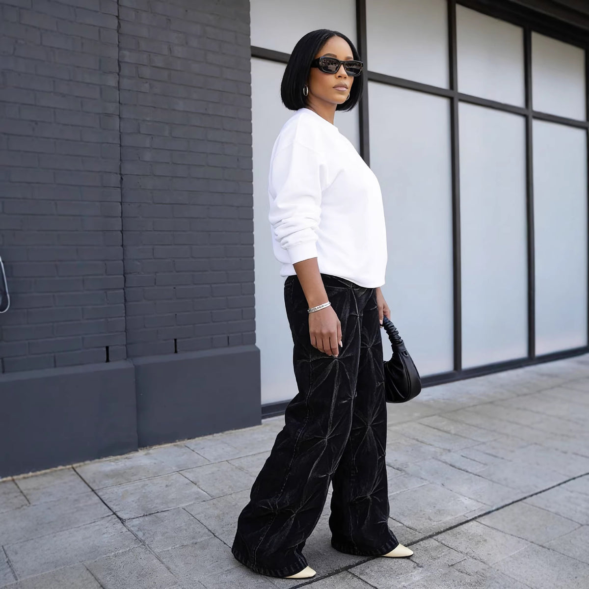 Eprolo street style dyed deconstructed pleated washed denim pants with distressed details and layered design.