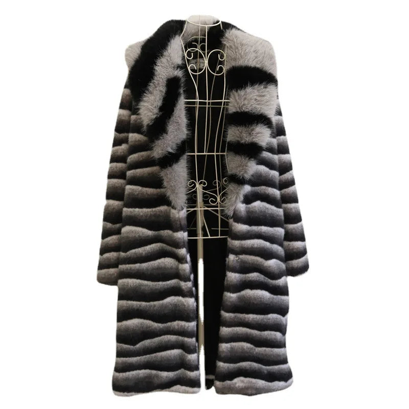 A black, grey, and white striped faux fur coat with a wide lapel collar on a mannequin.