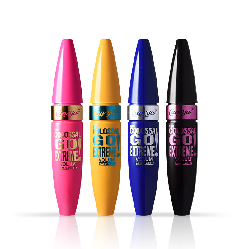 Four glossy mascara tubes in pink, yellow, blue, and black, featuring branded text and conical caps.