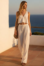 Women's V-neck sleeveless camisole top and wide-leg pants set by FitiqueFit, shown in a stylish matching outfit.
