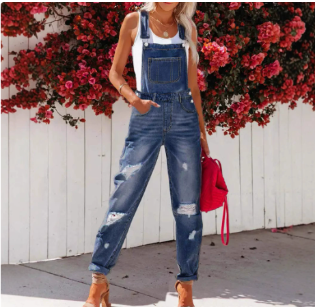Women's ripped denim overalls with streetwear strap bib design, featuring a trendy cropped fit and distressed details.