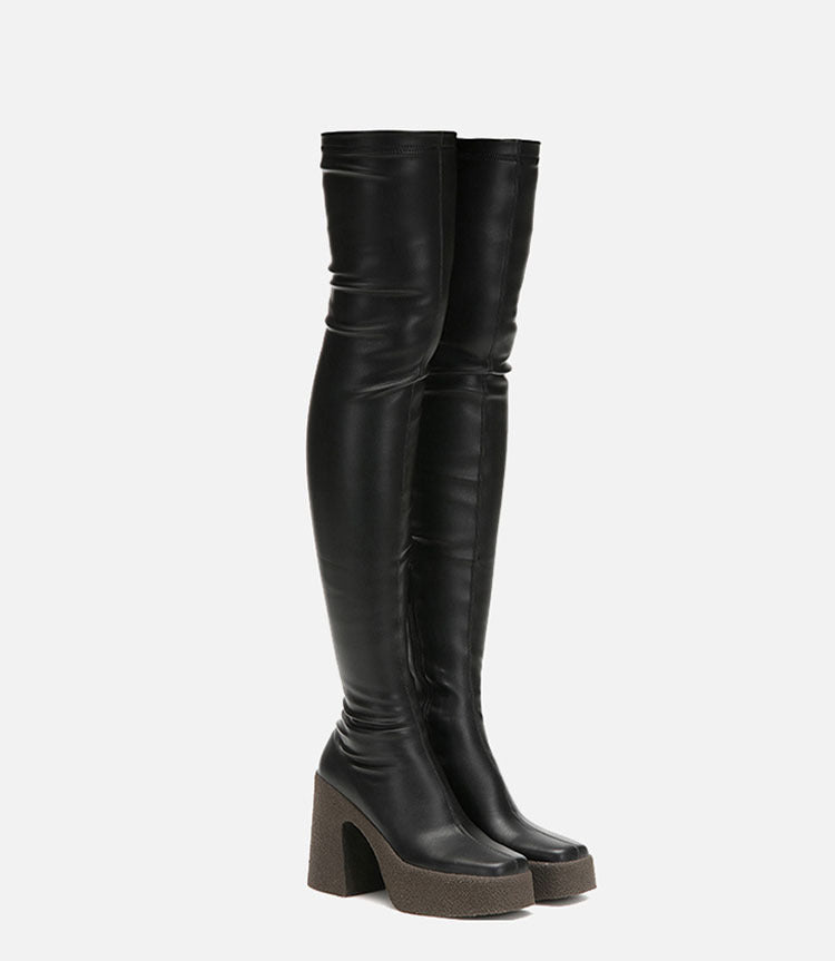 Black over-the-knee leather platform boots with textured chunky heels and square toes.