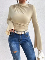 Black mock neck fitted top with ruched details and bell sleeves from Plush Fashion Hub, stylish and comfortable for casual wear.