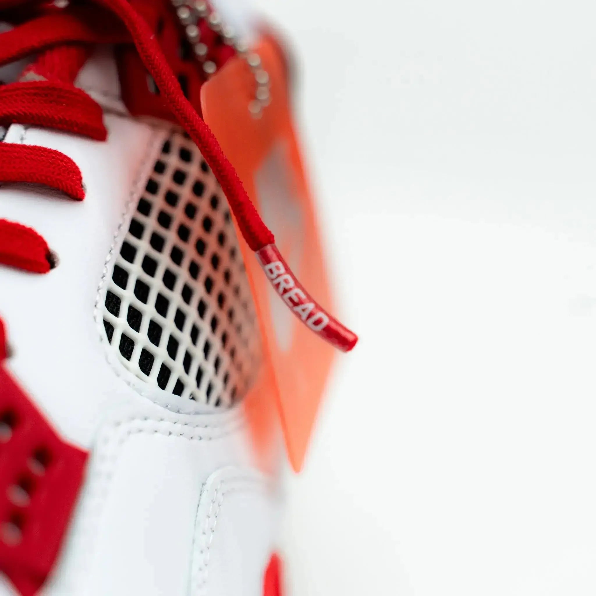 Red elastic shoelace by Plush Fashion Hub shown in close-up, highlighting its bright color and stretchy material for easy lacing.