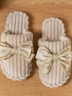 Women's bow-embellished cozy indoor slippers with cushioned EVA sole from Plush Fashion Hub, featuring soft plush material and stylish design.