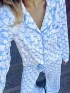 Women's bow print long sleeve pajama set from Plush Fashion Hub, includes button-down shirt and matching pants in soft loungewear fabric.
