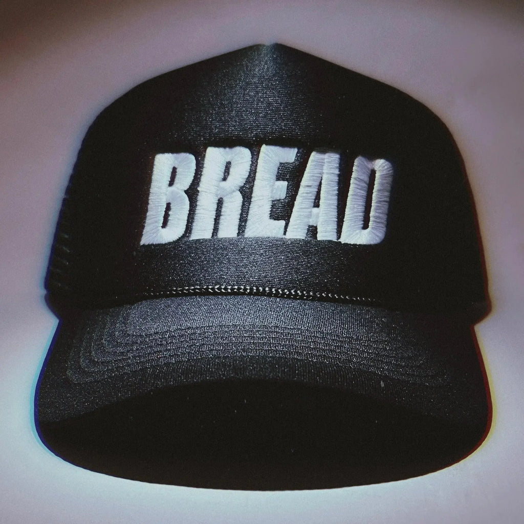 Bread Hat by Bread, a unique hat made to resemble a loaf of bread, shown in a close-up image highlighting its detailed design.