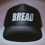 Bread Hat by Bread, a unique hat made to resemble a loaf of bread, shown in a close-up image highlighting its detailed design.
