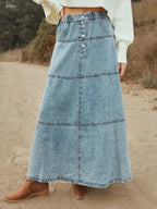 Flowy casual long denim maxi skirt with button-front tiers by Trendsi, featuring a relaxed, flowing silhouette and chic denim fabric.