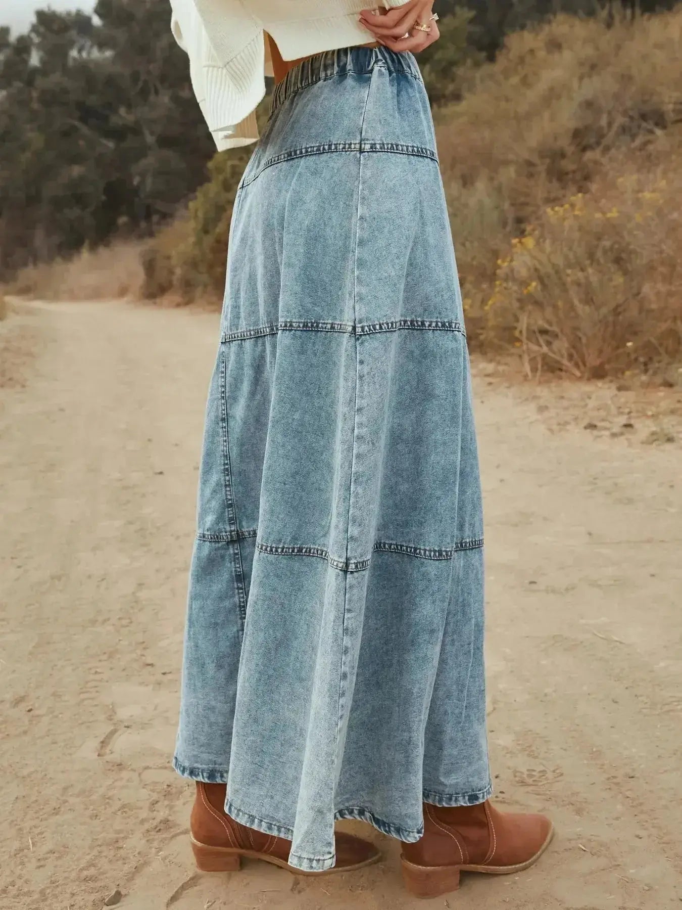 Flowy casual long denim maxi skirt with button-front tiers by Trendsi, featuring a relaxed fit and tiered design for a stylish look.