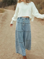 Flowy, casual long denim maxi skirt with button-front tiered design by Trendsi, perfect for a relaxed, stylish look.