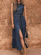 Sleeveless denim dress by Trendsi featuring button-front closure, tiered design, and matching belt for a stylish casual look.