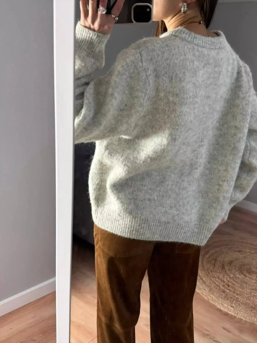 Soft knit long sleeve button-up cardigan by Plush Fashion Hub, featuring a classic design and cozy layering style.