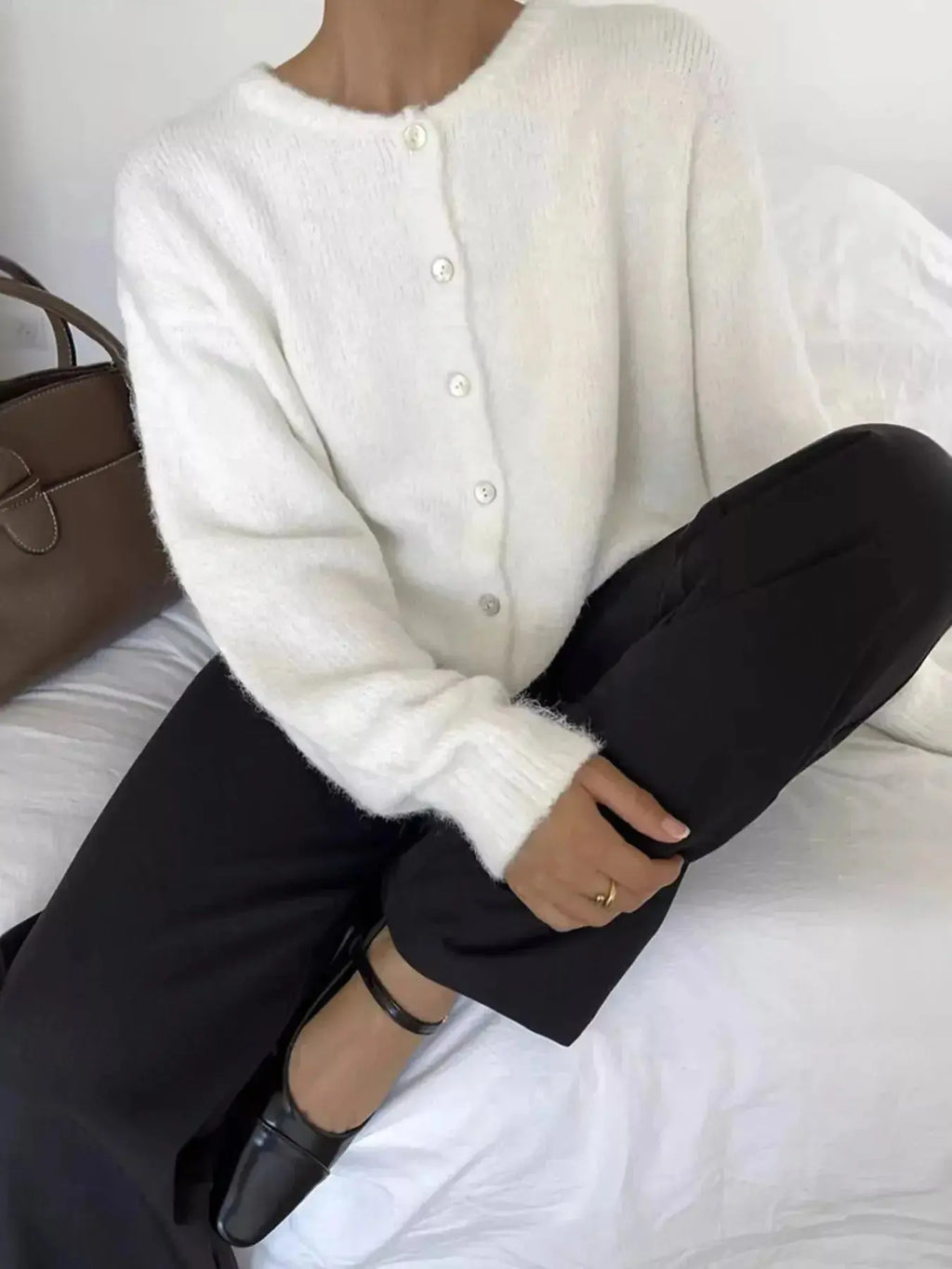 Soft knit long sleeve button-up cardigan sweater by Plush Fashion Hub, featuring a classic design and cozy layering style.