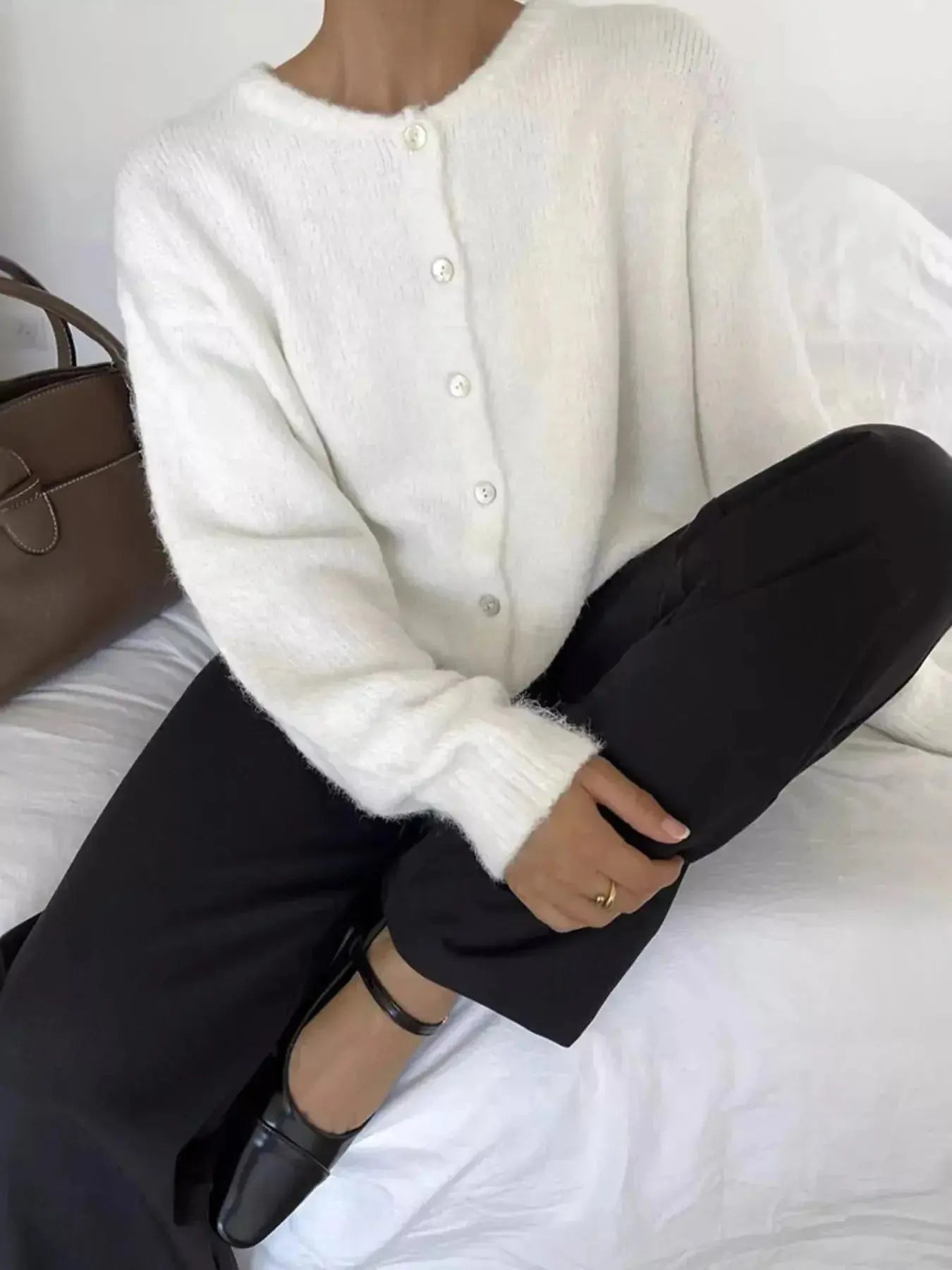 Soft knit long sleeve button-up cardigan sweater by Plush Fashion Hub, featuring a classic design and cozy layering style.