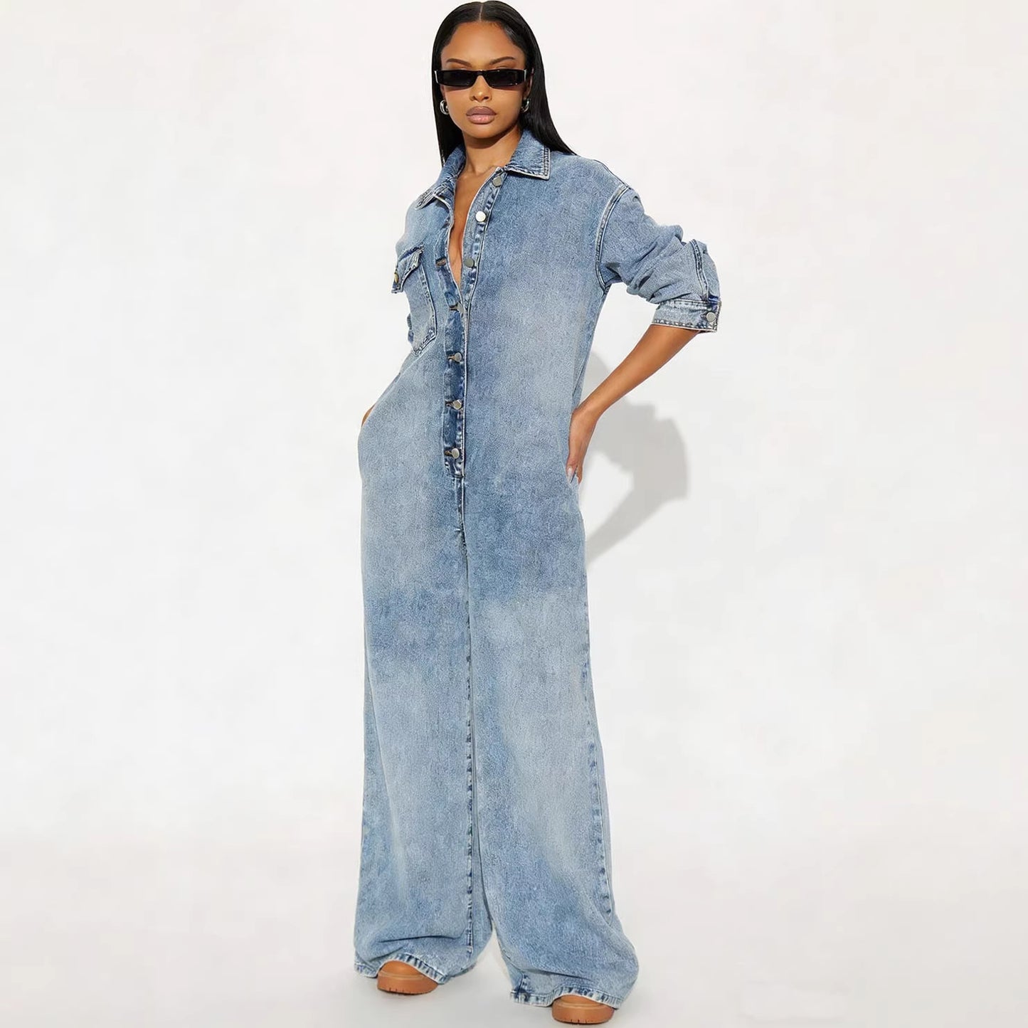 Women's long sleeve denim jumpsuit with button-front closure, from Plush Fashion Hub, displayed on a model.