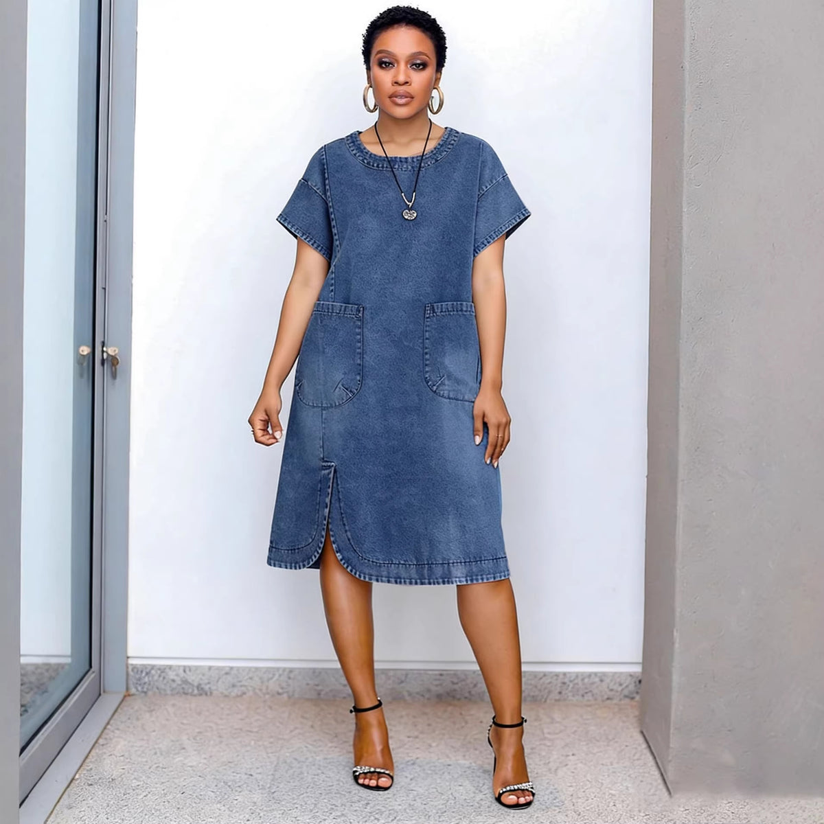 Casual eprolo denim dress with shoulder sleeves, short length, split design, and rounded hem on a model.