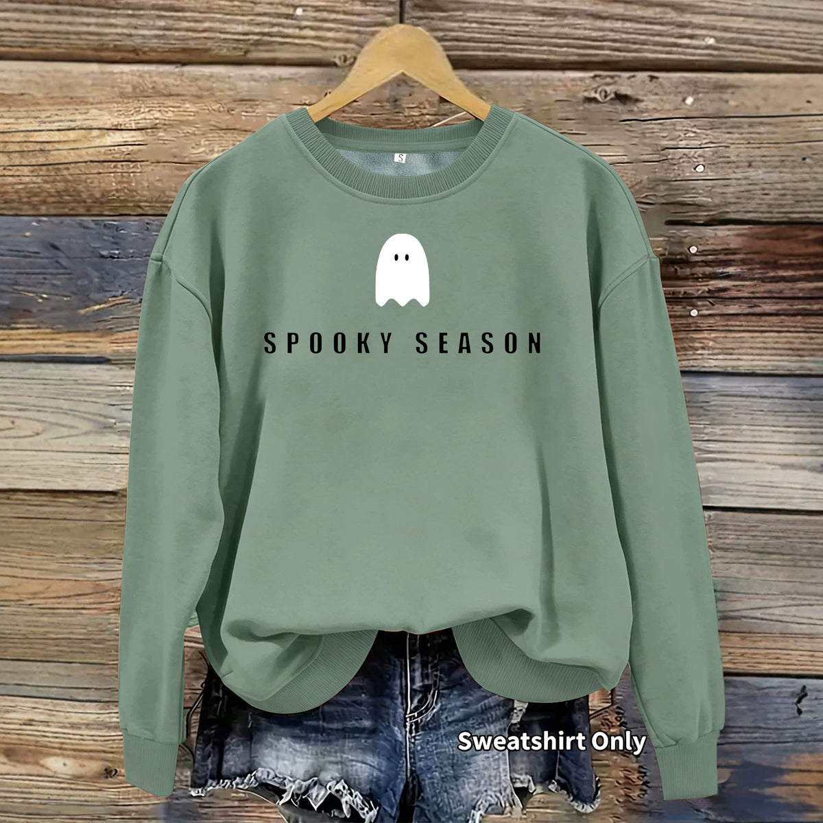 Sage green crewneck sweatshirt with a white ghost and the black text SPOOKY SEASON on the front.