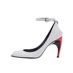 Modern white leather pointed-toe stiletto with ankle strap, silver buckle, and colorblock red and black sculptural heel.