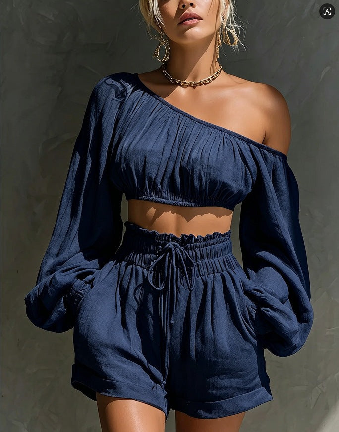 Women's one-shoulder ruched crop top and high-waist shorts set by Plush Fashion Hub, shown in a stylish, coordinated outfit.