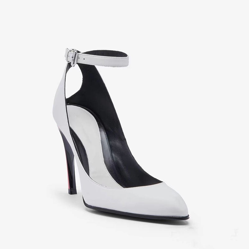 White pointed-toe stiletto with ankle strap, buckle, black interior, and a two-tone heel with a red accent detail.